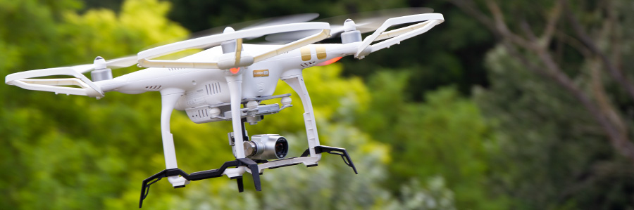 close shot of drone flying in wooded area